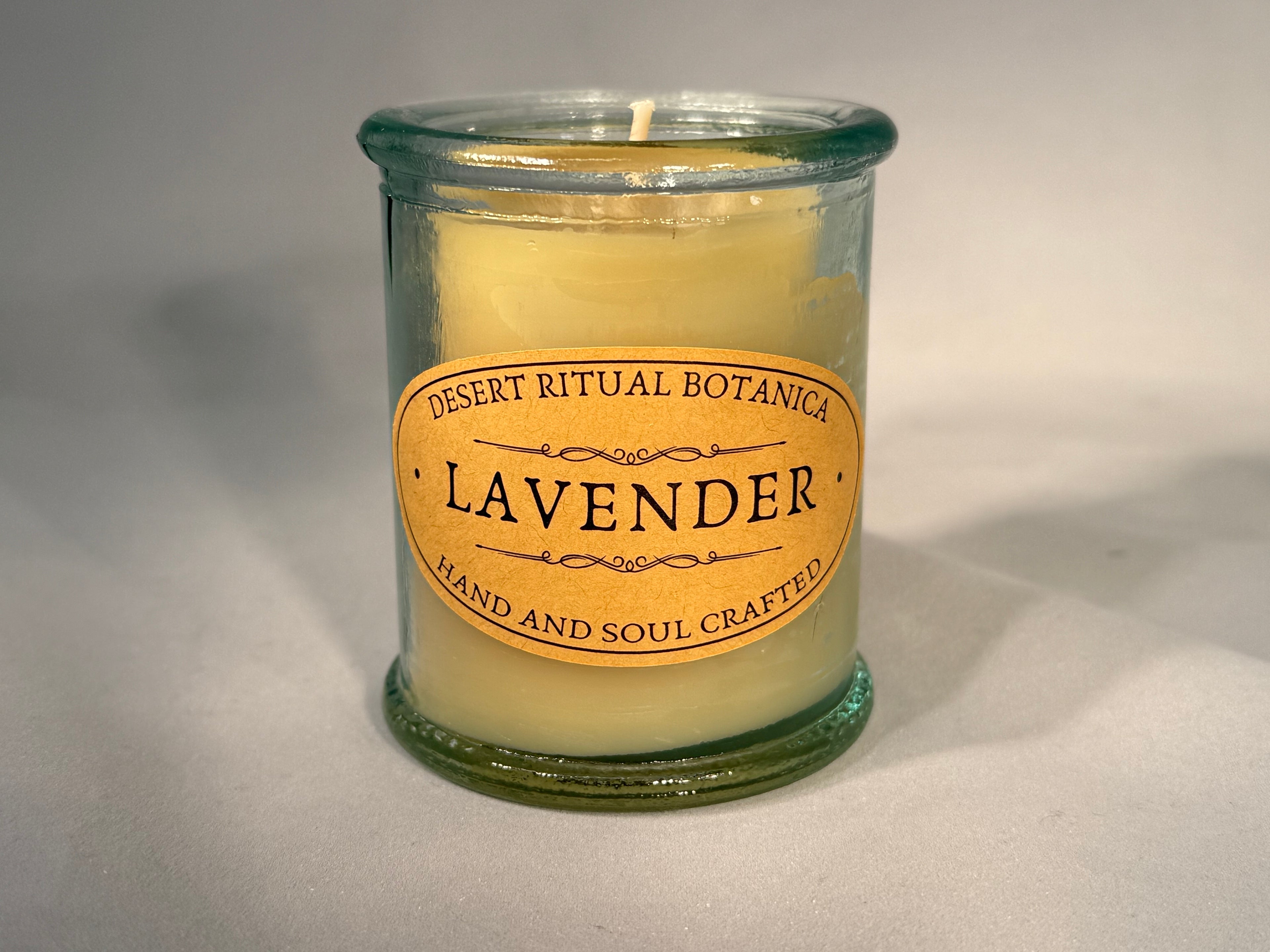 Organic beeswax candle infused with pure lavender essential oil in a reusable glass jar, hand-poured for calming rituals and natural relaxation.